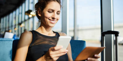 Woman submitting expense report on phone