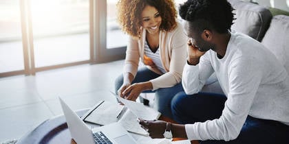 man and woman sitting with computer