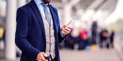 man waiting outside of airport