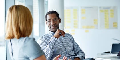 Man sitting talking to woman