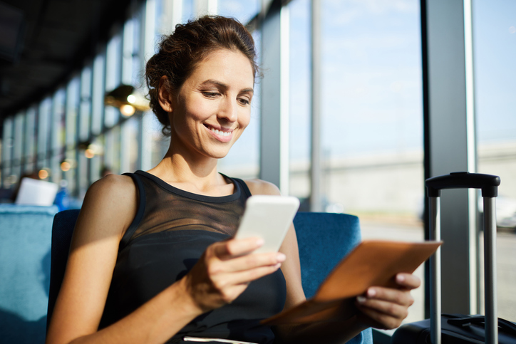 Woman submitting expense report on phone