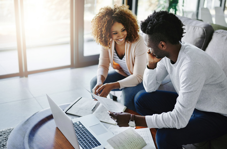 man and woman sitting with computer