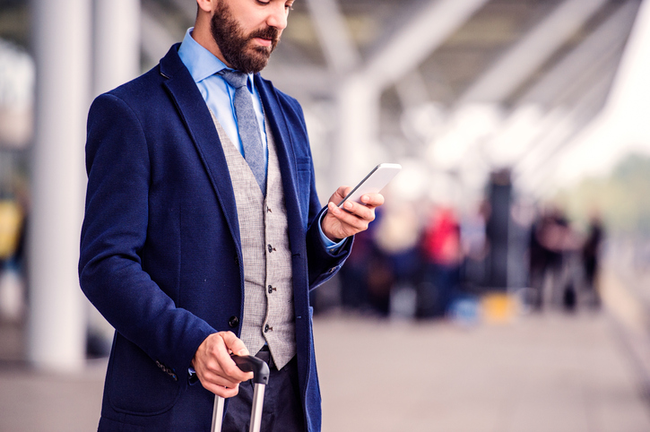 man waiting outside of airport