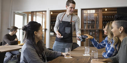 image of restaurant server taking a receipt for an unusual employee expense